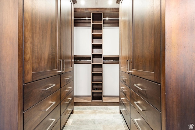 spacious closet featuring light wood-style flooring