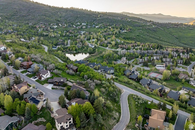 aerial view of property and surrounding area featuring nearby suburban area and mountains