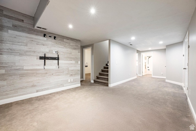 finished below grade area with stairs, recessed lighting, baseboards, and carpet