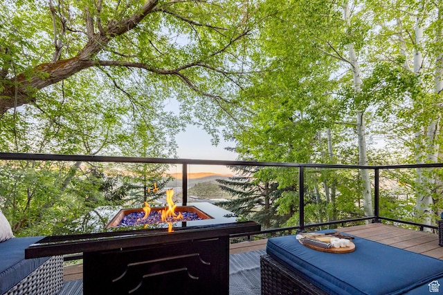 view of wooden balcony featuring a fire pit and a wooden deck