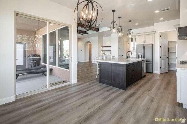 3208 S Sand Stone Dr, Hurricane, UT 84737 - kitchen with arched walkways, stainless steel fridge, a chandelier, light countertops, and recessed lighting