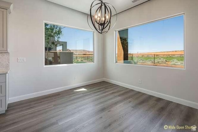 3208 S Sand Stone Dr, Hurricane, UT 84737 - unfurnished dining area with a chandelier, baseboards, and wood finished floors