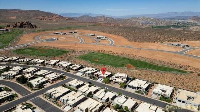 3208 S Sand Stone Dr, Hurricane, UT 84737 - aerial overview of property's location with a mountain backdrop and nearby suburban area