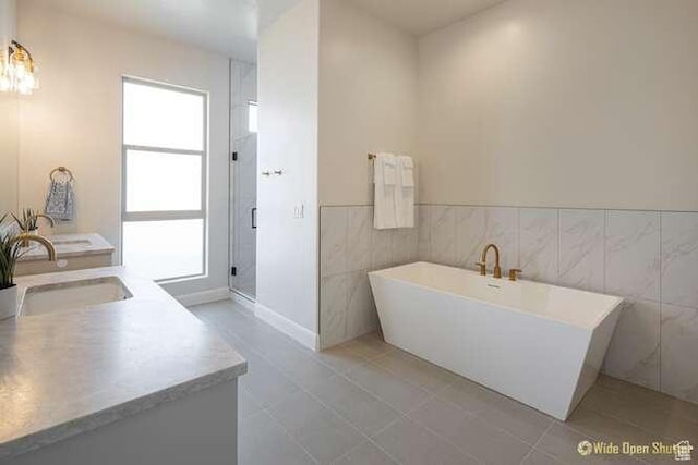 3208 S Sand Stone Dr, Hurricane, UT 84737 - full bath featuring a stall shower, a freestanding tub, vanity, tile walls, and tile patterned flooring