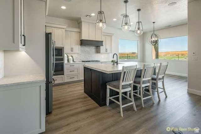3208 S Sand Stone Dr, Hurricane, UT 84737 - kitchen featuring appliances with stainless steel finishes, decorative backsplash, baseboards, a breakfast bar area, and dark wood-type flooring
