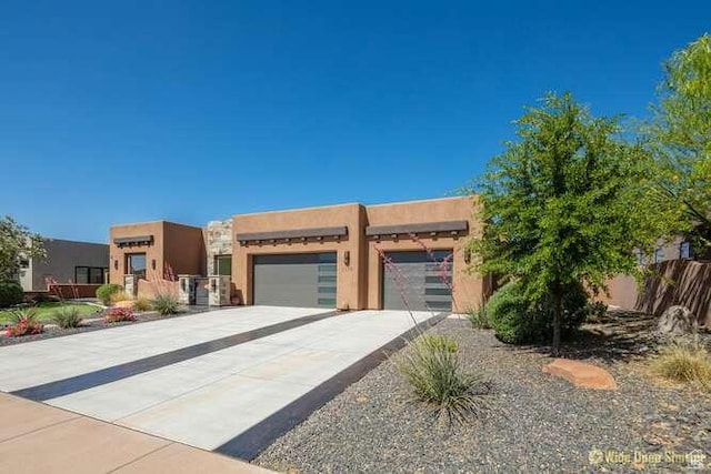 3208 S Sand Stone Dr, Hurricane, UT 84737 - adobe home featuring concrete driveway, stucco siding, and an attached garage