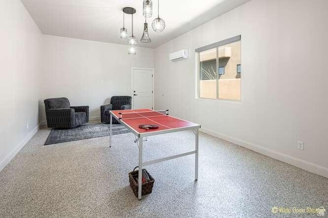 3208 S Sand Stone Dr, Hurricane, UT 84737 - playroom featuring an AC wall unit, baseboards, and speckle patterned floor