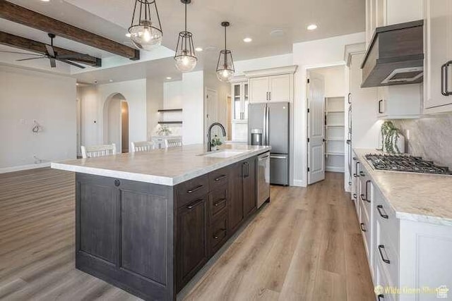3208 S Sand Stone Dr, Hurricane, UT 84737 - kitchen with a sink, extractor fan, stainless steel appliances, arched walkways, and ceiling fan