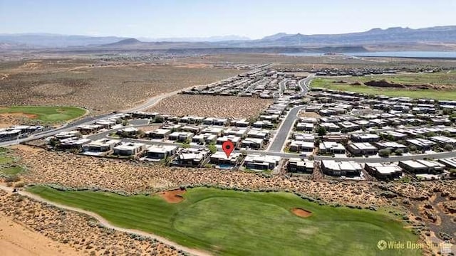 3208 S Sand Stone Dr, Hurricane, UT 84737 - aerial view of residential area with a local golf course and a mountainous background