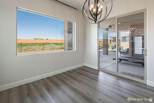 3208 S Sand Stone Dr, Hurricane, UT 84737 - unfurnished dining area with a chandelier, plenty of natural light, baseboards, and wood finished floors
