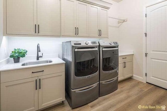 3208 S Sand Stone Dr, Hurricane, UT 84737 - laundry area with washing machine and dryer, light wood-style floors, cabinet space, and baseboards