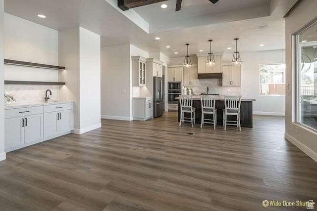 3208 S Sand Stone Dr, Hurricane, UT 84737 - kitchen featuring open shelves, baseboards, appliances with stainless steel finishes, a kitchen breakfast bar, and dark wood-style flooring