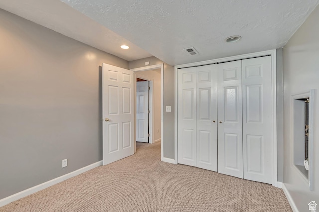 2057 W Marblewood Dr, Riverton, UT 84065 - unfurnished bedroom with light colored carpet, a textured ceiling, a closet, baseboards, and recessed lighting
