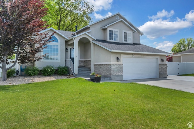 2057 W Marblewood Dr, Riverton, UT 84065 - view of front of property with brick siding, stucco siding, concrete driveway, and a garage