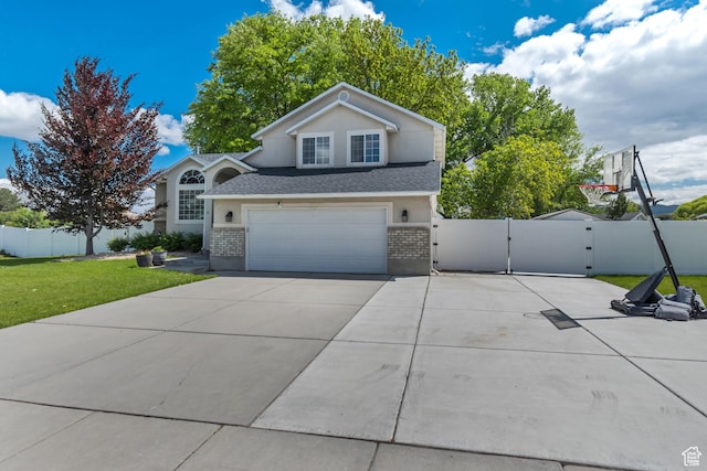2057 W Marblewood Dr, Riverton, UT 84065 - view of front of home featuring brick siding, a gate, driveway, an attached garage, and roof with shingles