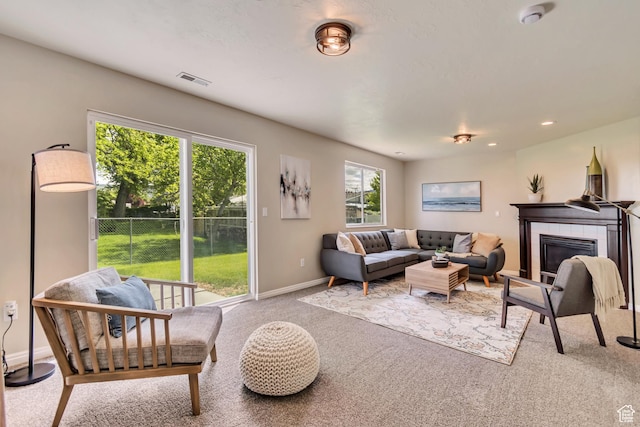 2057 W Marblewood Dr, Riverton, UT 84065 - carpeted living area featuring baseboards, a tile fireplace, and recessed lighting