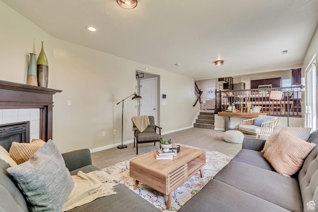 2057 W Marblewood Dr, Riverton, UT 84065 - carpeted living room featuring stairs, baseboards, and a tiled fireplace