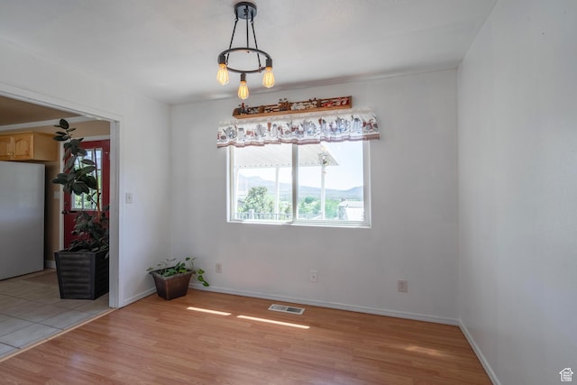 328 Hillcrest Cir, Central, UT 84722 - unfurnished dining area featuring plenty of natural light, light wood-style flooring, and baseboards