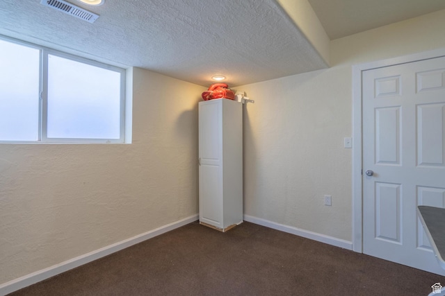 328 Hillcrest Cir, Central, UT 84722 - spare room with dark colored carpet, baseboards, and a textured ceiling