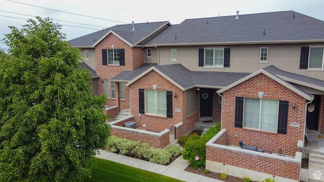 161 S 2775 W, West Point, UT 84015 - view of front facade with brick siding, stucco siding, and roof with shingles