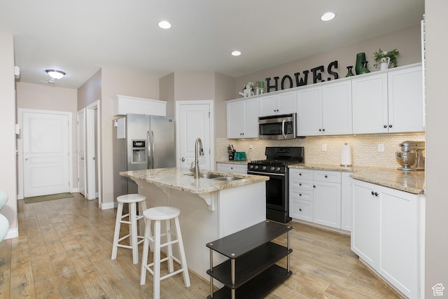 161 S 2775 W, West Point, UT 84015 - kitchen featuring appliances with stainless steel finishes, a sink, backsplash, white cabinetry, and recessed lighting