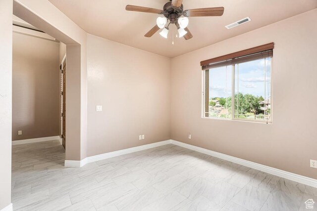 8 S Arroyo Dr, St George, UT 84790 - empty room featuring a ceiling fan, baseboards, and light marble finish floors
