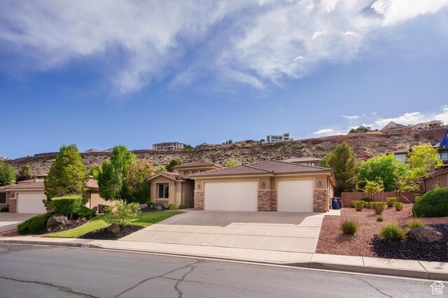 8 S Arroyo Dr, St George, UT 84790 - prairie-style house featuring a garage, driveway, stone siding, and stucco siding
