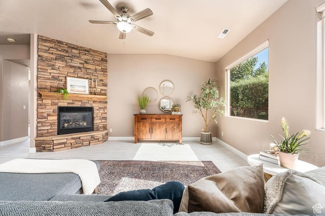 8 S Arroyo Dr, St George, UT 84790 - living room featuring a ceiling fan, vaulted ceiling, a stone fireplace, and baseboards