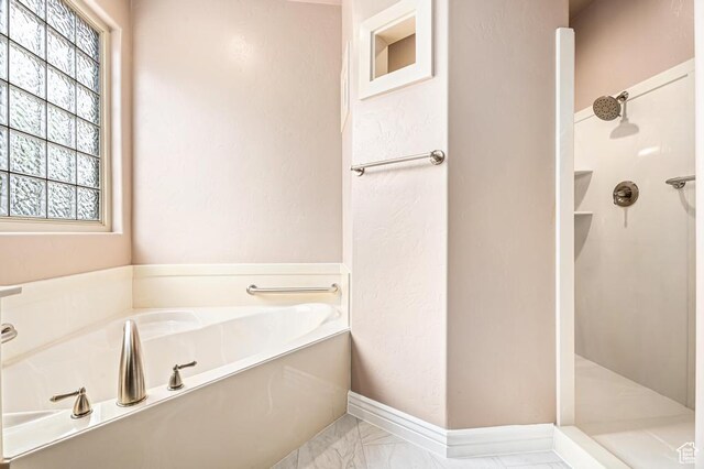 8 S Arroyo Dr, St George, UT 84790 - full bath with walk in shower, marble look tile flooring, a garden tub, and baseboards