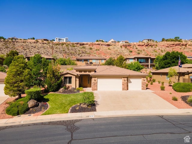 8 S Arroyo Dr, St George, UT 84790 - prairie-style home with a garage, concrete driveway, a tiled roof, stucco siding, and a front yard