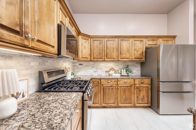 8 S Arroyo Dr, St George, UT 84790 - kitchen with stainless steel appliances, light stone countertops, brown cabinets, and tasteful backsplash