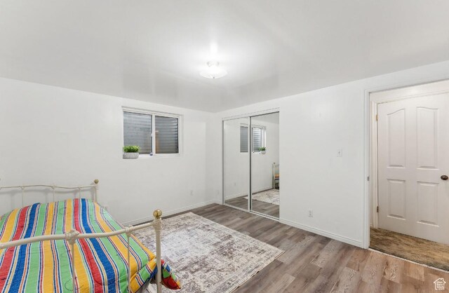 635 E Pioneer Ave S, Sandy, UT 84070 - bedroom with wood finished floors, a closet, and baseboards