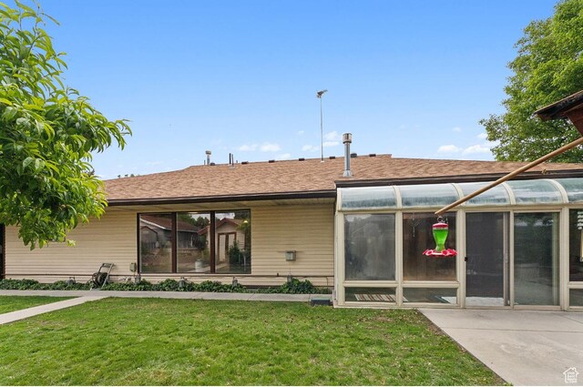 635 E Pioneer Ave S, Sandy, UT 84070 - rear view of house featuring a sunroom and a yard