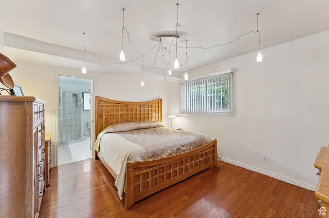 635 E Pioneer Ave S, Sandy, UT 84070 - bedroom with wood finished floors, baseboards, and ensuite bath