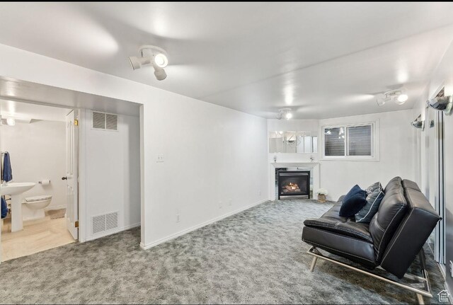 635 E Pioneer Ave S, Sandy, UT 84070 - carpeted living area with a glass covered fireplace and baseboards