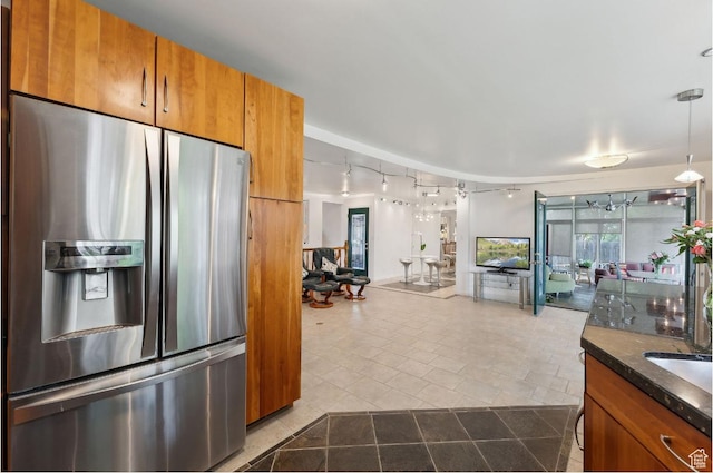 635 E Pioneer Ave S, Sandy, UT 84070 - kitchen featuring stainless steel fridge, brown cabinetry, track lighting, and open floor plan
