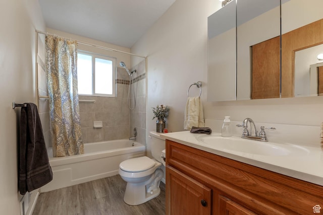 full bathroom with toilet, wood finished floors, shower / bath combo with shower curtain, and vanity