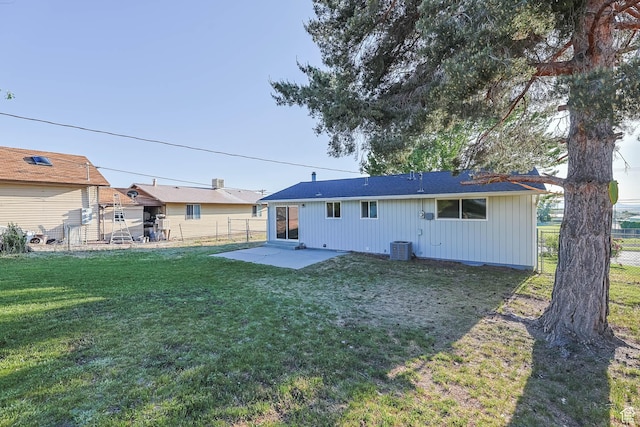 rear view of house with a patio, board and batten siding, and cooling unit