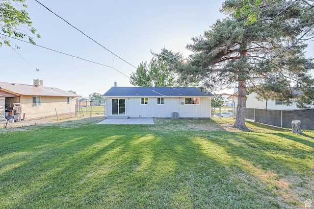 rear view of property featuring a patio and central AC