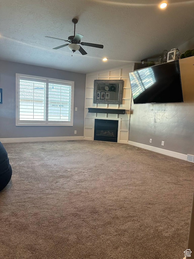 1783 E 2000 S, Naples, UT 84078 - unfurnished living room with baseboards, ceiling fan, a textured ceiling, carpet, and a fireplace