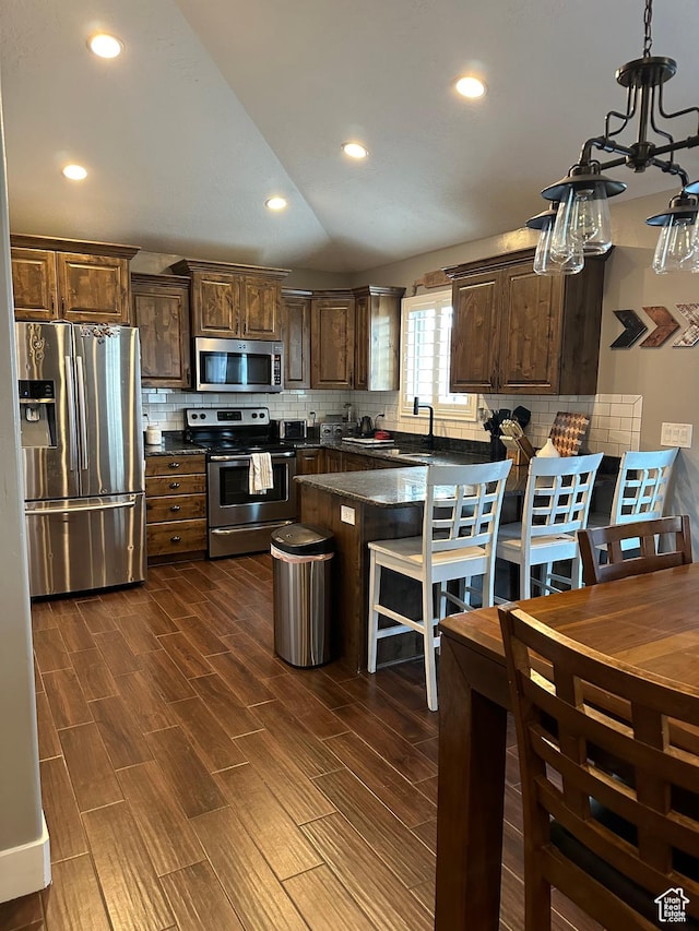 1783 E 2000 S, Naples, UT 84078 - kitchen with stainless steel appliances, dark countertops, backsplash, dark wood-style flooring, and recessed lighting