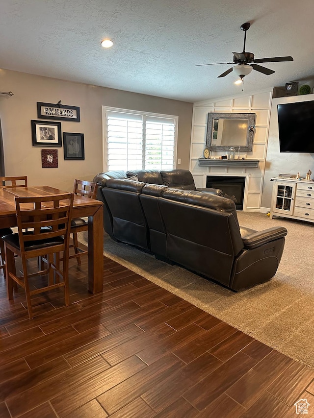 1783 E 2000 S, Naples, UT 84078 - living room featuring a ceiling fan, a textured ceiling, dark wood-type flooring, and a fireplace
