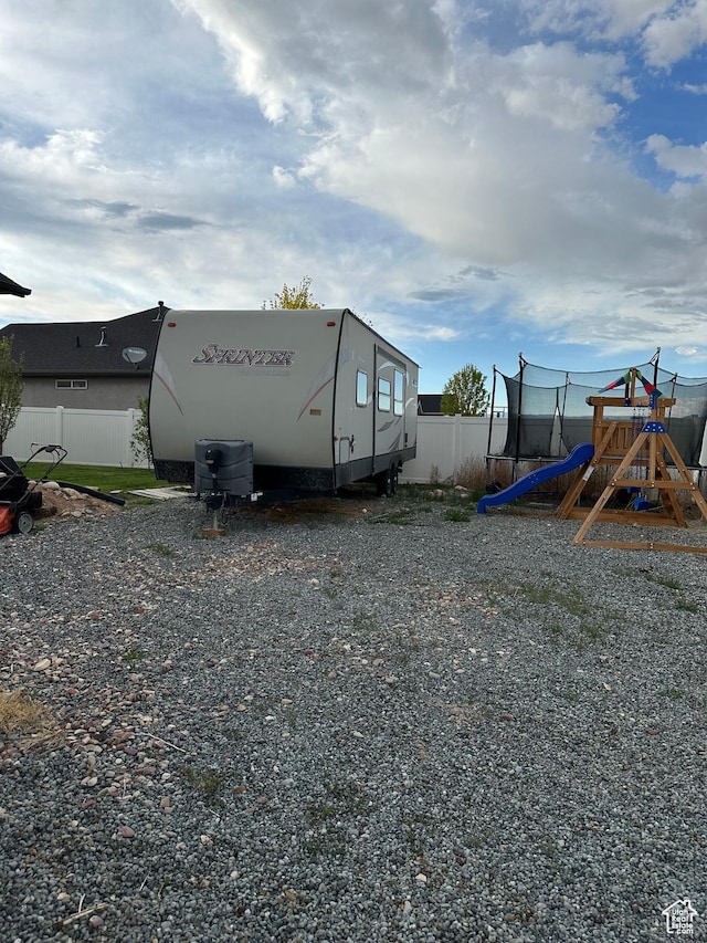 1783 E 2000 S, Naples, UT 84078 - view of side of home featuring a trampoline and a playground