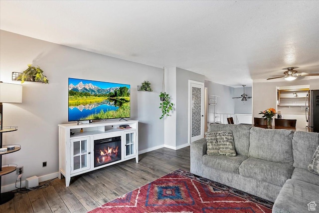5667 S Aspen Ct E, South Ogden, UT 84403 - living area featuring a ceiling fan, wood finished floors, and baseboards
