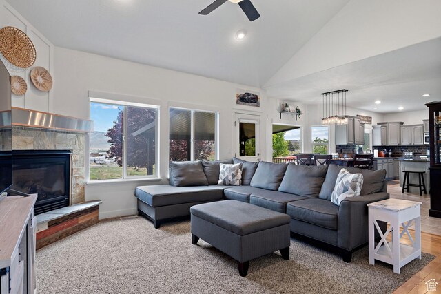 667 W Aspen Hills Blvd N, Saratoga Springs, UT 84045 - living area featuring a ceiling fan, a glass covered fireplace, recessed lighting, light wood-style floors, and baseboards