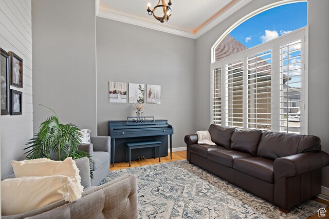 667 W Aspen Hills Blvd N, Saratoga Springs, UT 84045 - living room with wood finished floors, plenty of natural light, a chandelier, and ornamental molding