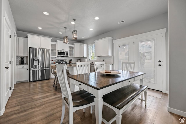 7886 N Bridleway Rd, Eagle Mountain, UT 84005 - dining area featuring dark wood finished floors, recessed lighting, and baseboards