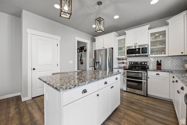 7886 N Bridleway Rd, Eagle Mountain, UT 84005 - kitchen featuring stainless steel appliances, dark stone countertops, tasteful backsplash, dark wood-style flooring, and recessed lighting