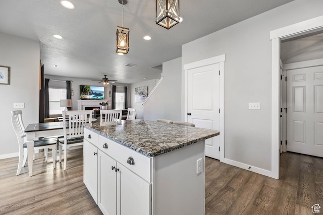 7886 N Bridleway Rd, Eagle Mountain, UT 84005 - kitchen featuring a center island, a ceiling fan, dark wood-style floors, recessed lighting, and white cabinetry