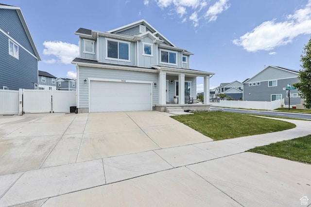 7886 N Bridleway Rd, Eagle Mountain, UT 84005 - view of front of house featuring covered porch, board and batten siding, a garage, concrete driveway, and a residential view